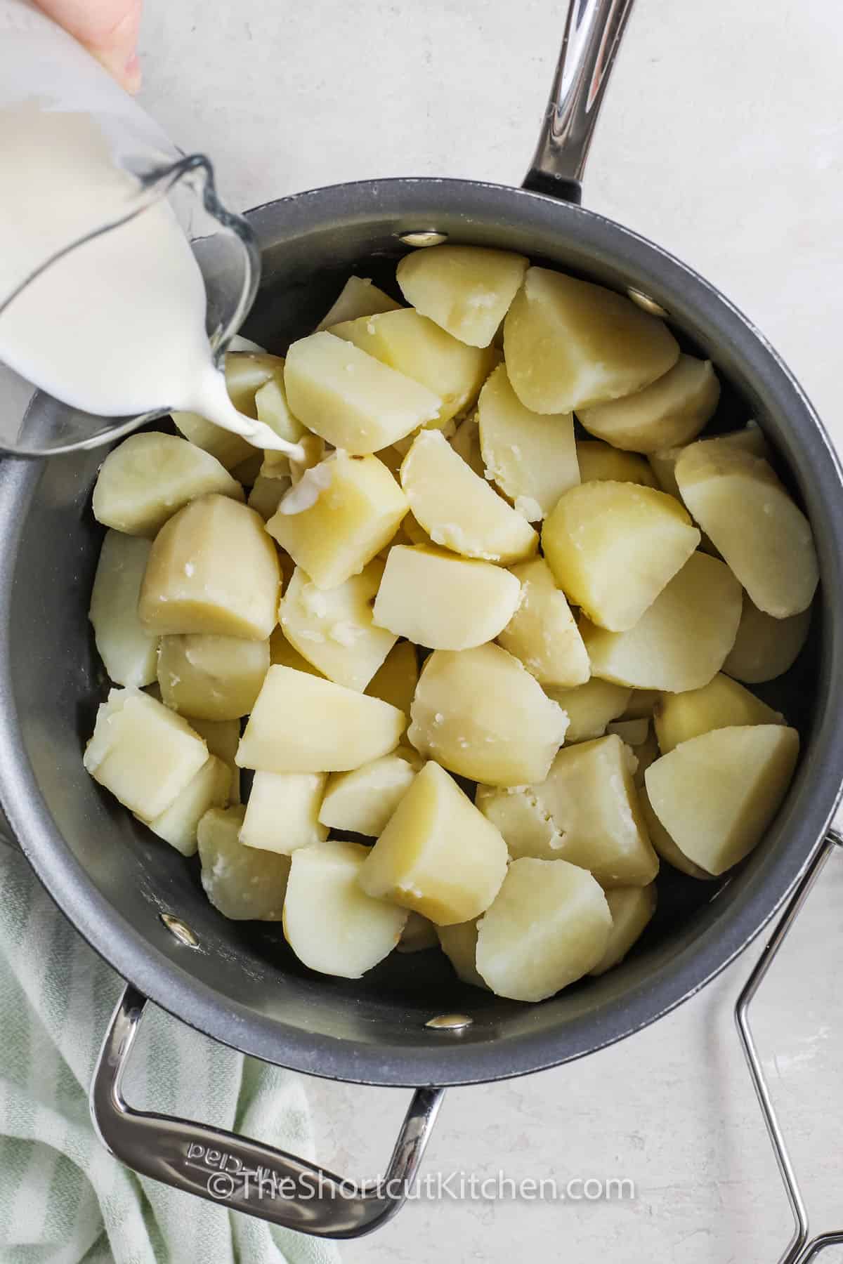 adding milk to potatoes to make Colcannon Recipe