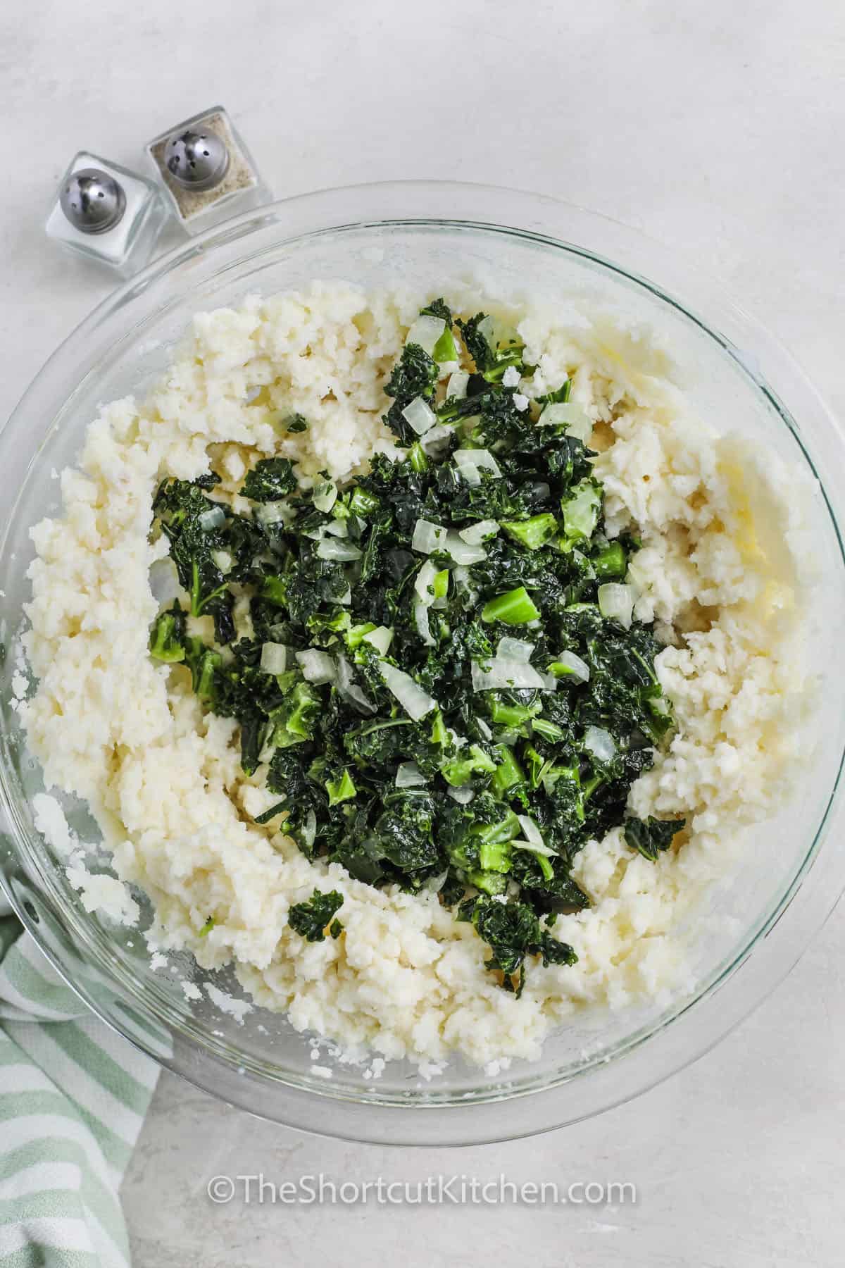 adding spinach mix to potatoes to make Colcannon Recipe