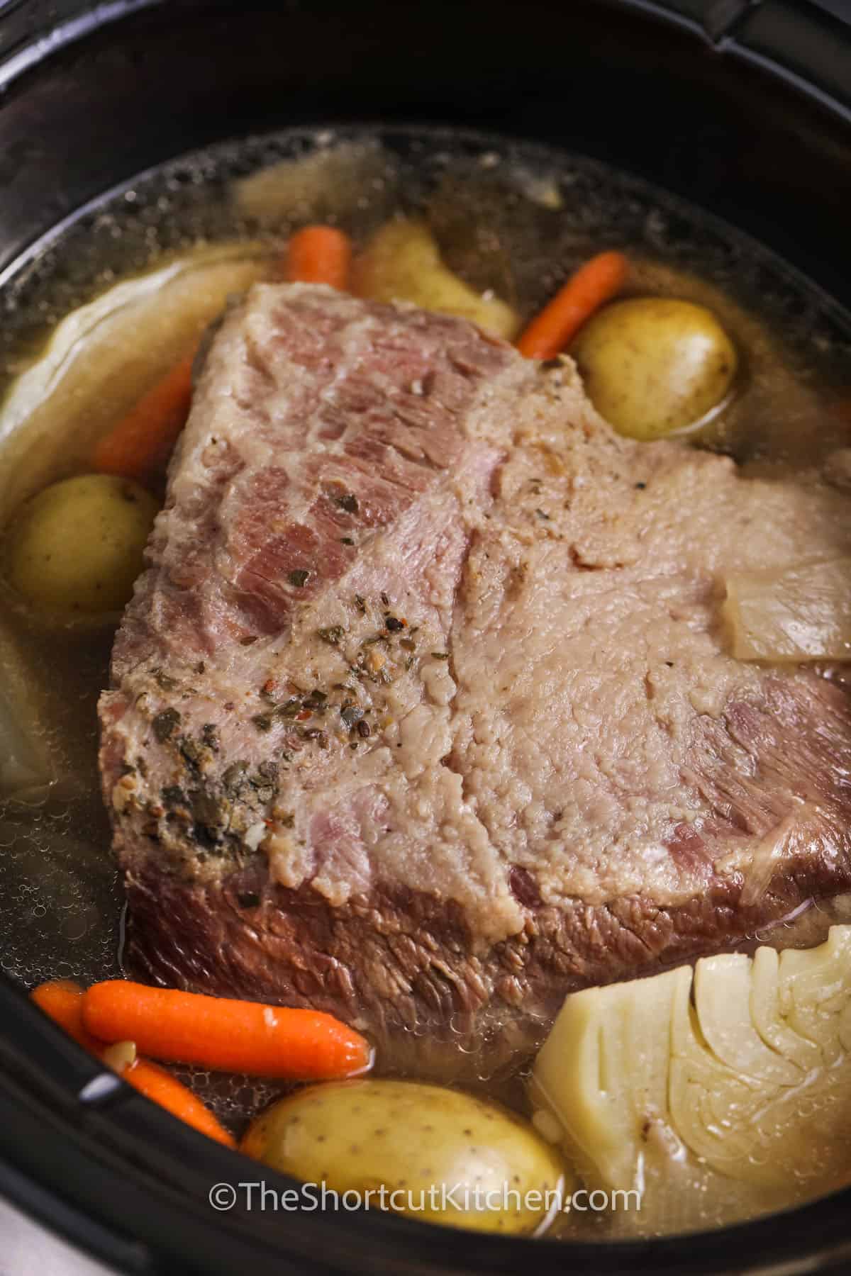 Crock Pot Corned Beef and Cabbage cooking in the slow cooker