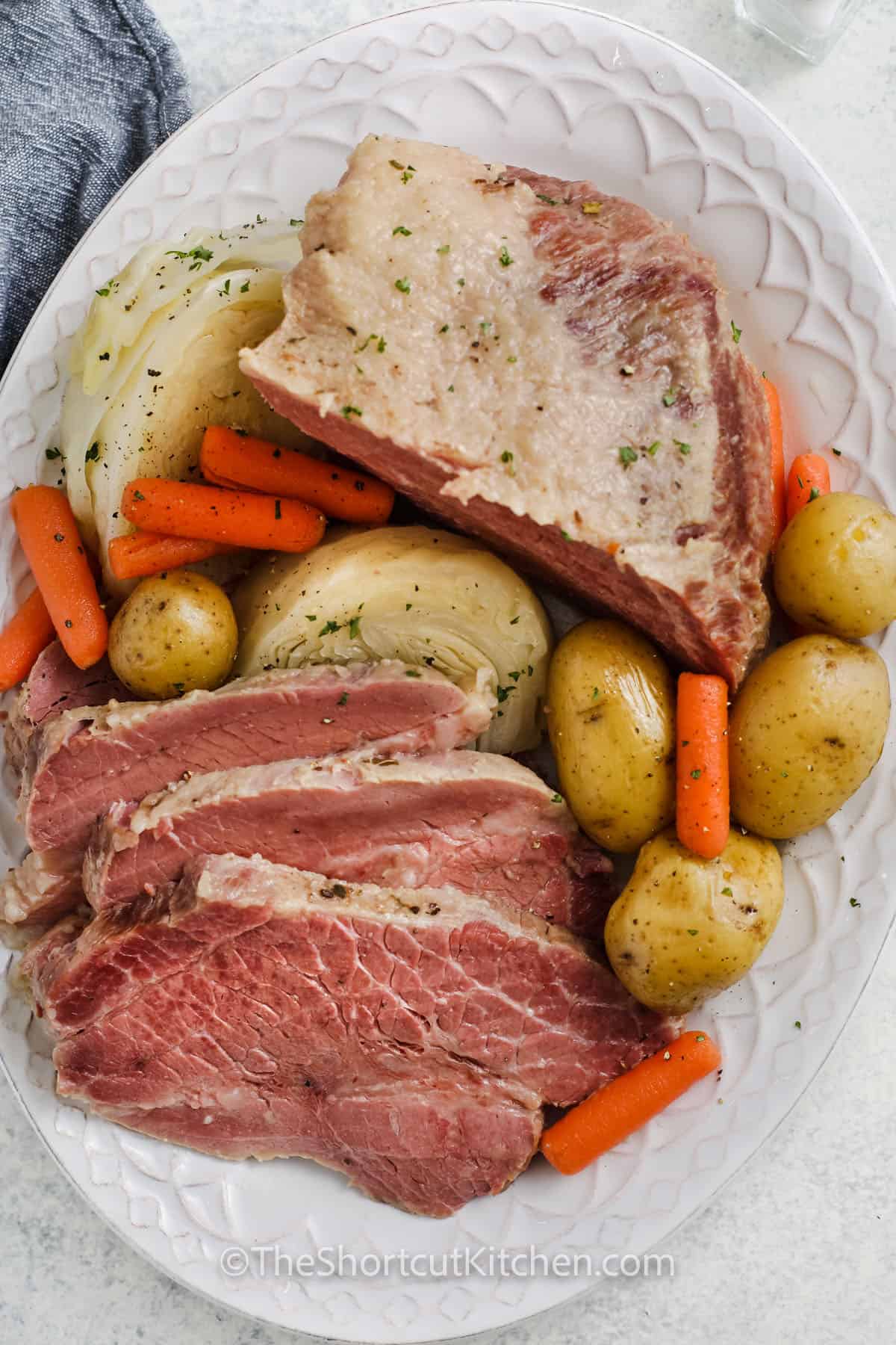 Crock Pot Corned Beef and Cabbage on a plate with with potatoes and carrots