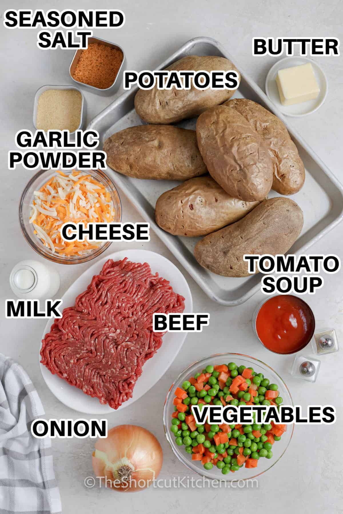 potatoes , butter , tomato soup , vegetable , onion , beef , milk , cheese , garlic powder and seasoned salt with labels to make Cottage Pie Baked Potatoes