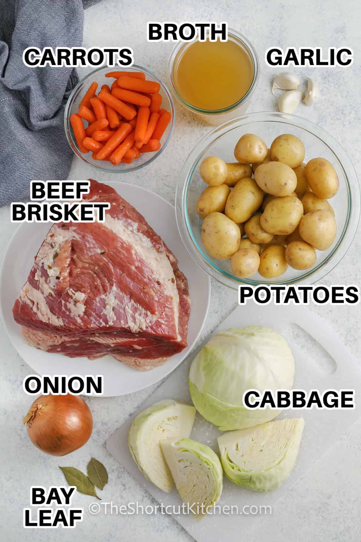 broth , carrots , garlic , potatoes , cabbage , onion , bay leaf with labels to make Crock Pot Corned Beef and Cabbage