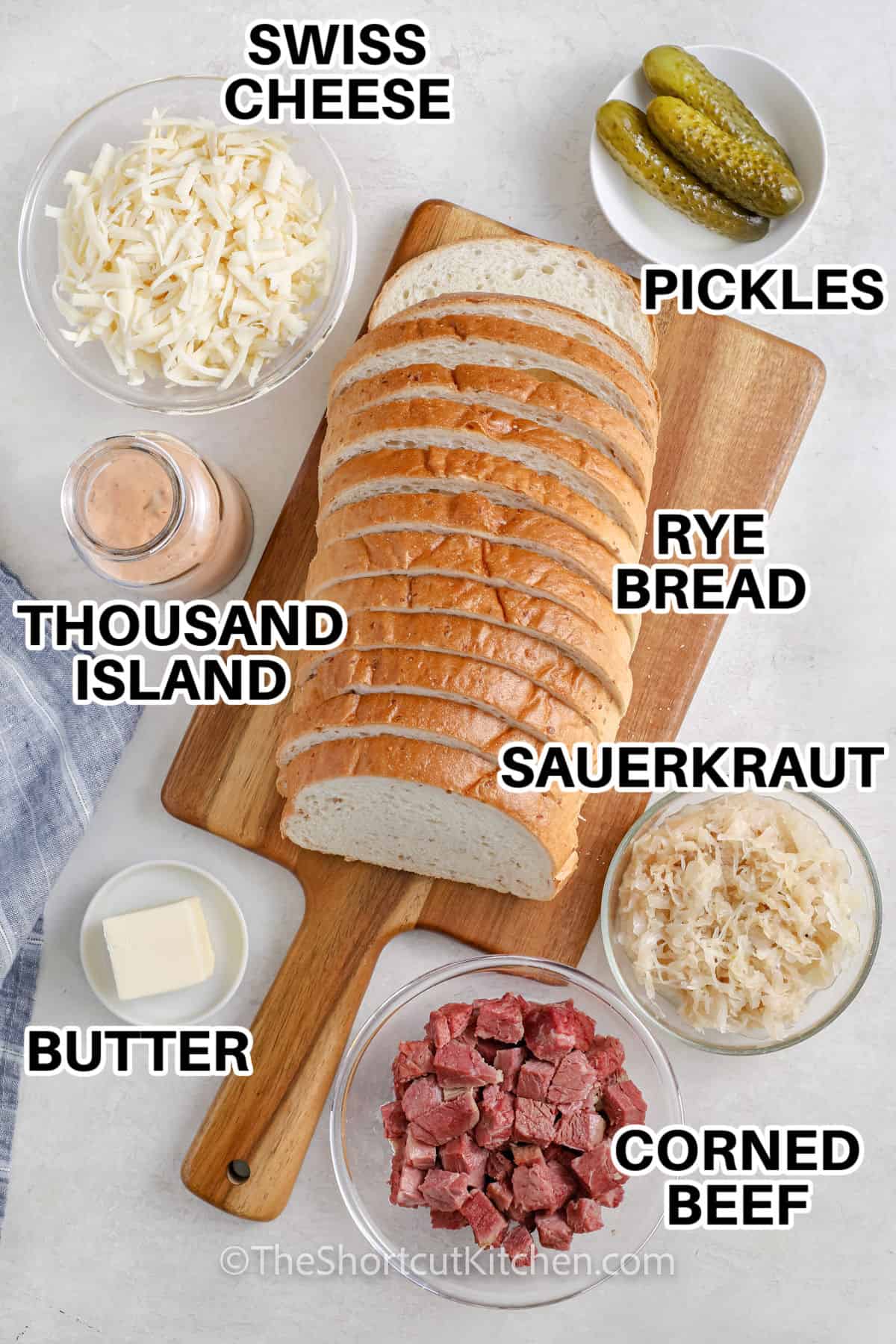 Swiss cheese , pickles , rye bread , thousand island , sauerkraut , butter , corned beef with labels to make Reuben Casserole