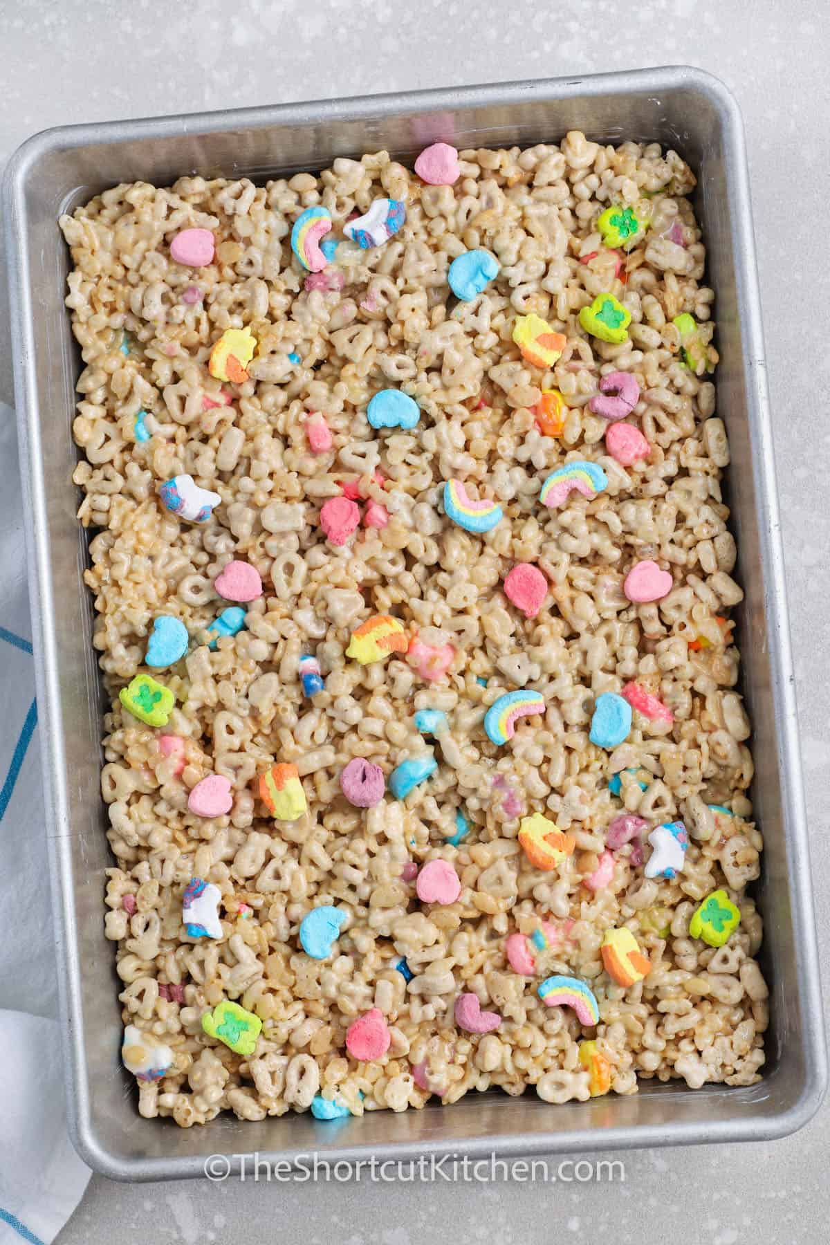 Lucky Charms Rice Krispie Treats pressed into a baking dish