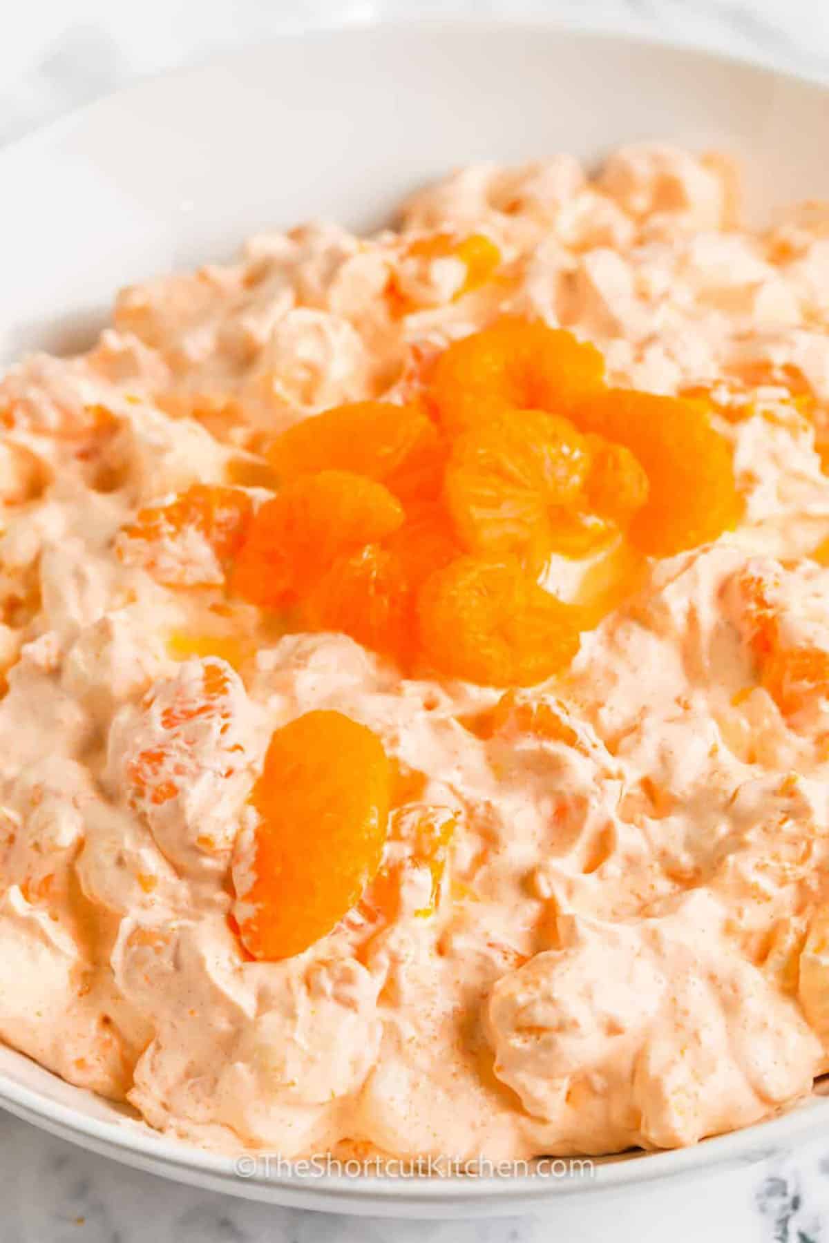 bowl of Cottage Cheese Orange Jello Salad with mandarin oranges on top