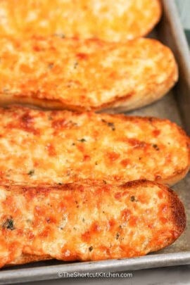 close up of the best cheesy bread recipe on a baking sheet