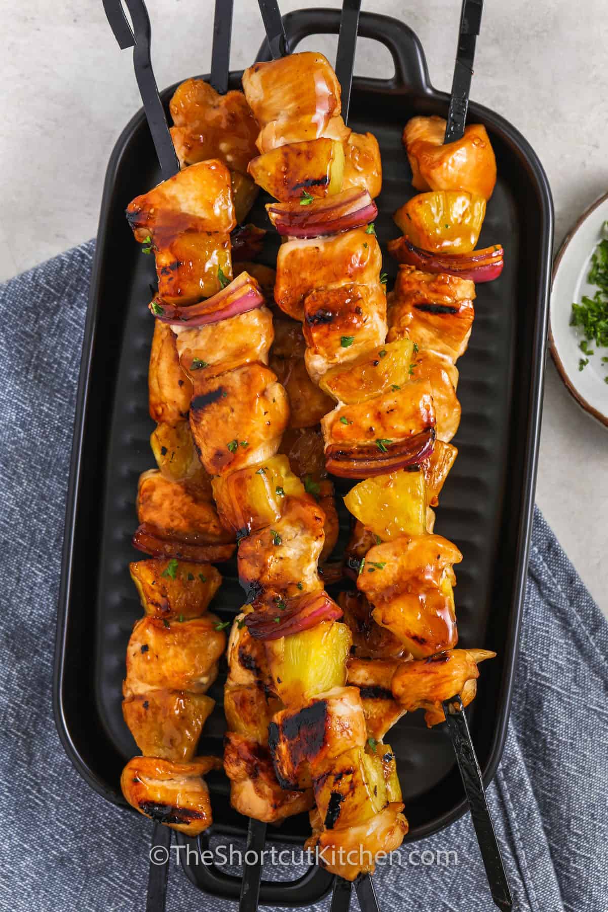 skewered grilled pineapple chicken kabobs on a grill