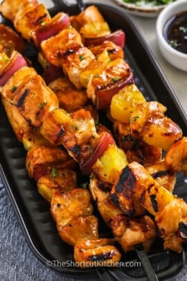 cooked chicken kabobs on a grill