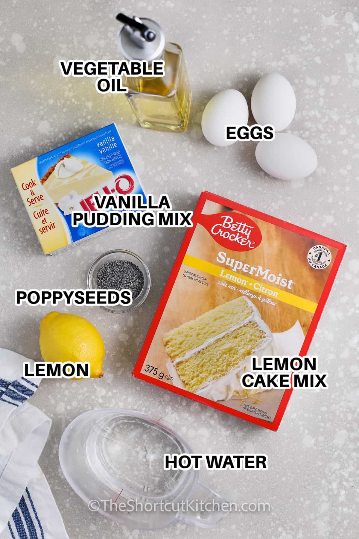 Ingredients to make Lemon Poppyseed Muffins labeled: vegetable oil, eggs, vanilla pudding mix, poppyseeds, lemon cake mix, lemon, and hot water