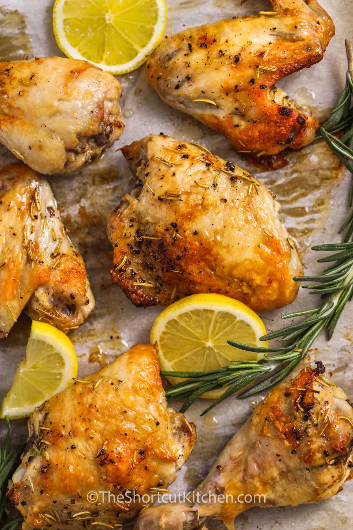 pieces of Lemon Rosemary Chicken with lemon slices and rosemary