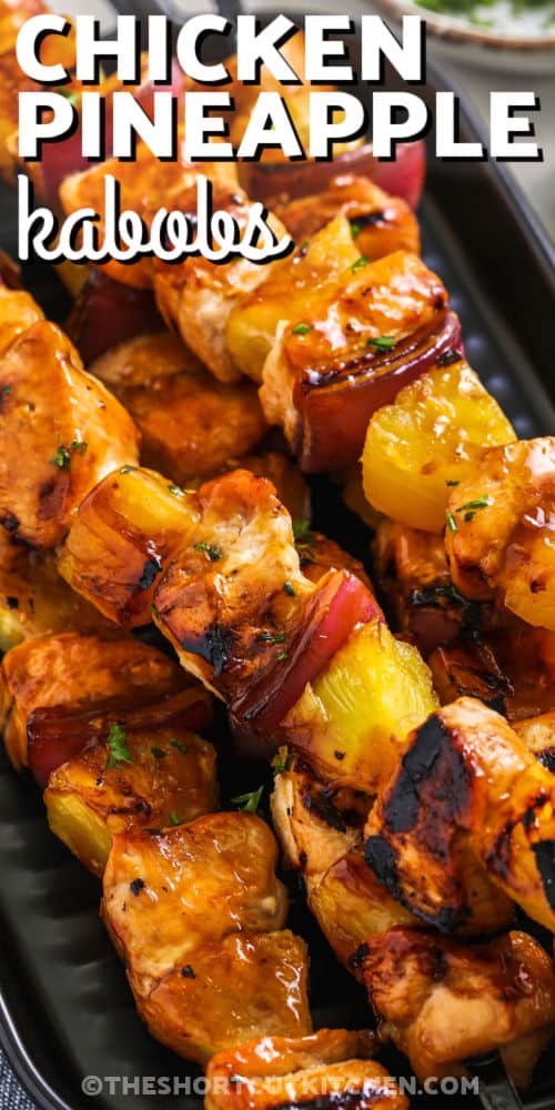 cooked chicken pineapple kabobs on a grill with writing
