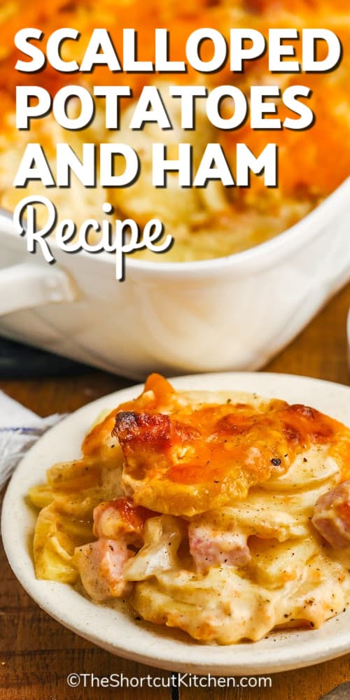 Easy Scalloped Potatoes and Ham on a white plate, with a baking dish in the background, with a title