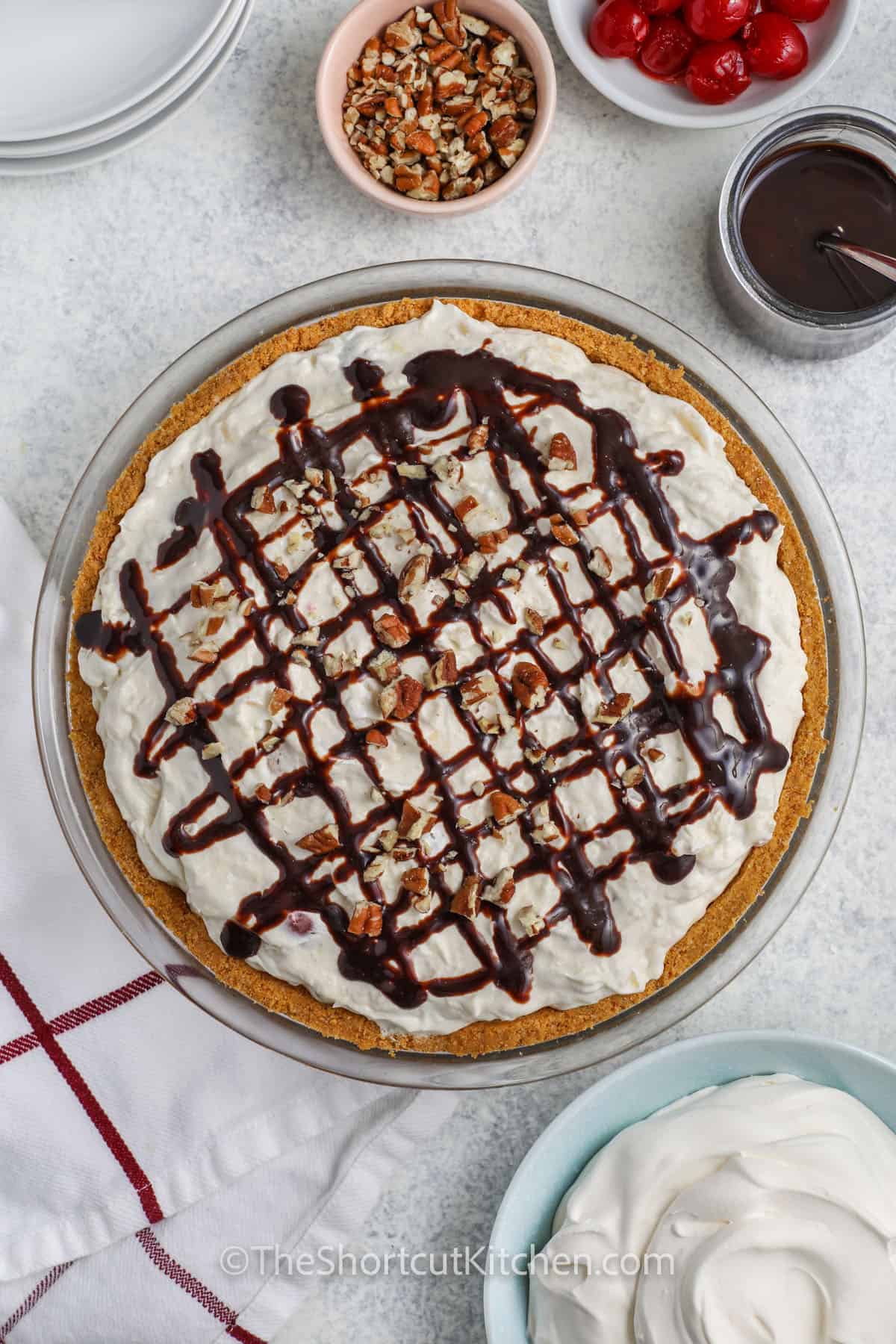 Banana Split Pie with nuts and chocolate syrup on top