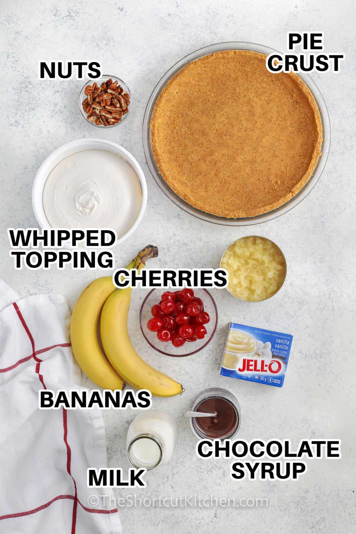 pie crust , nuts , whipped topping , cherries , bananas , vanilla pudding mix , chocolate syrup , and milk with labels to make Banana Split Pie