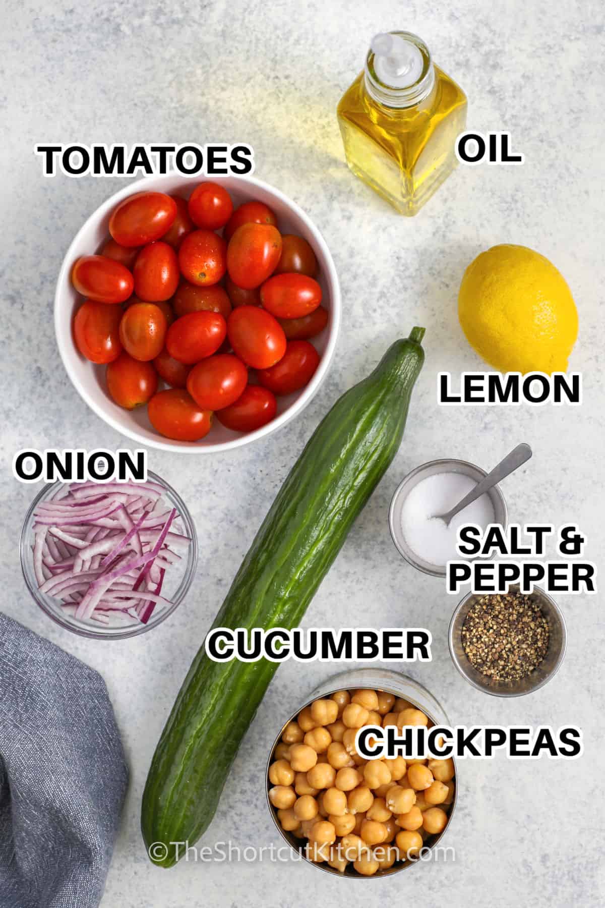 oil , tomatoes , lemon , salt and pepper , cucumber , chickpeas and onion with labels to make Chickpea Salad Recipe