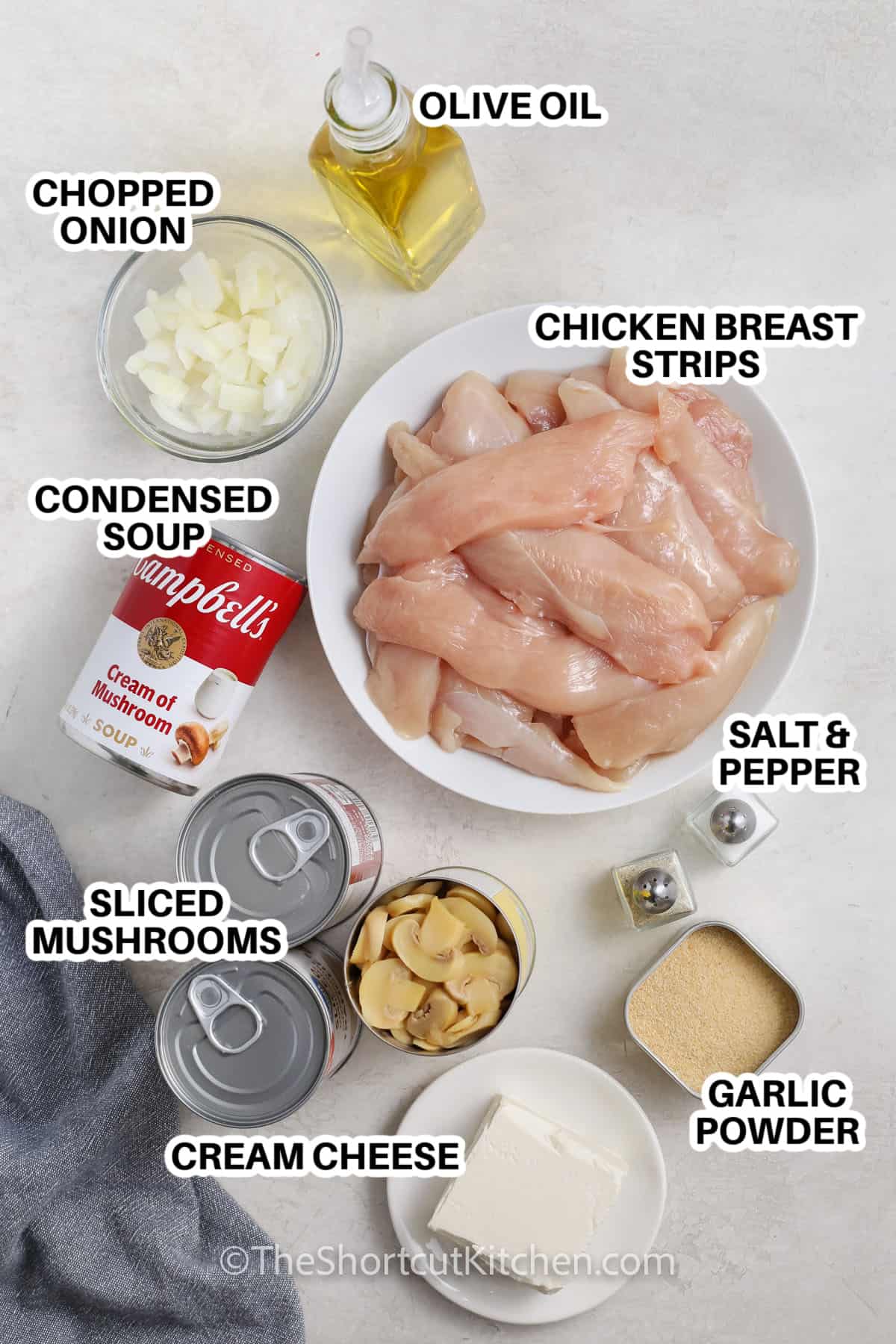 chicken breast strips, onion, condensed soup, sliced mushrooms, cream cheese, garlic powder, salt & pepper, and olive oil assembled to make creamy chicken mushroom casserole