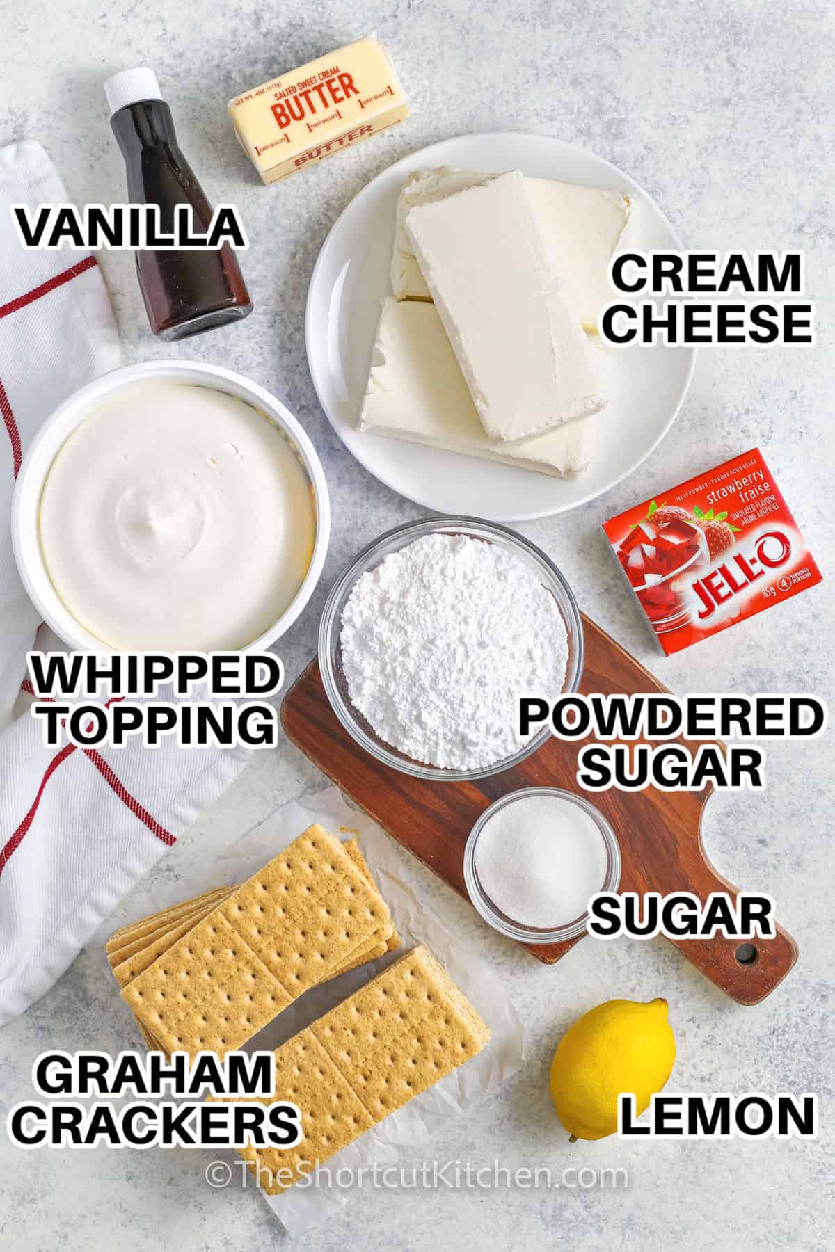 vanilla , butter ,cream cheese , strawberry hello , powdered sugar , sugar , lemon , graham crackers and whipped topping to make No Bake Strawberry Cheesecake Bars
