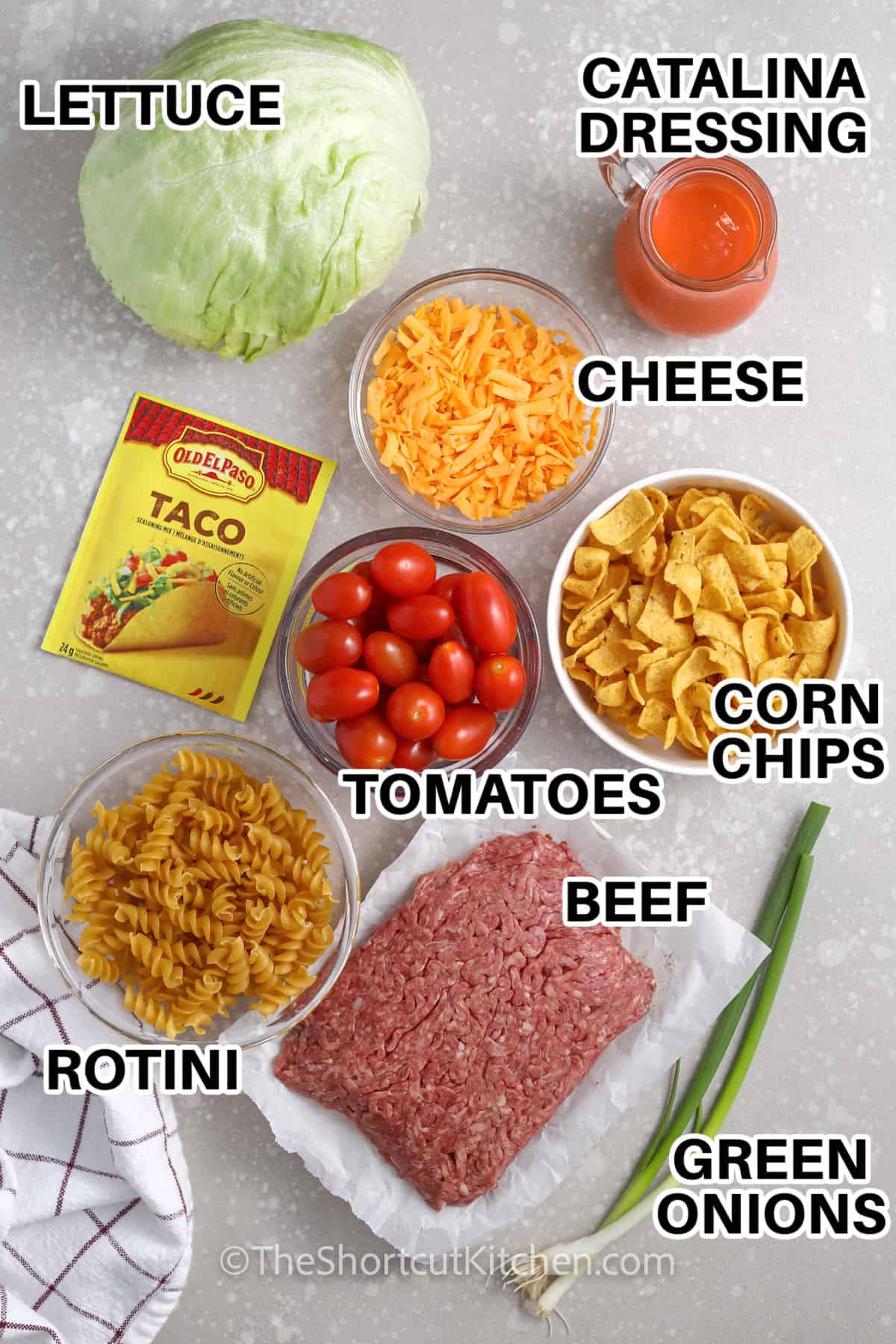 lettuce , catalina dressing , cheese, corn chips , tomatoes , beef , rotini , green onions and taco seasoning with labels to make Taco Pasta Salad