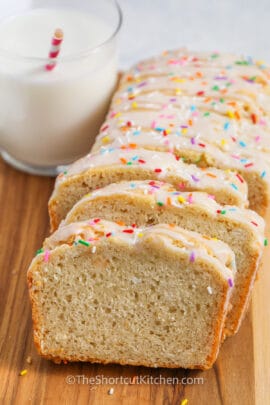 loaf of Ice Cream Bread Recipe cut into slices with glass of milk