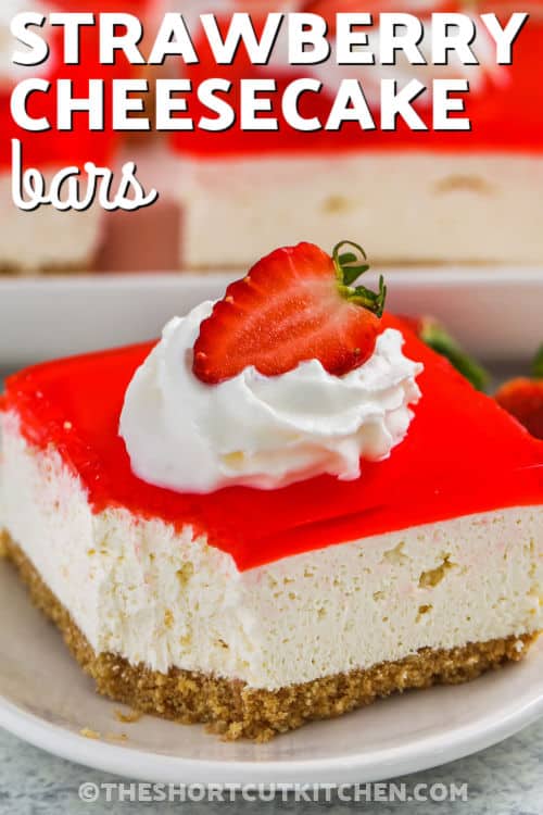 No Bake Strawberry Cheesecake Bars with a bite taken out of one and writing