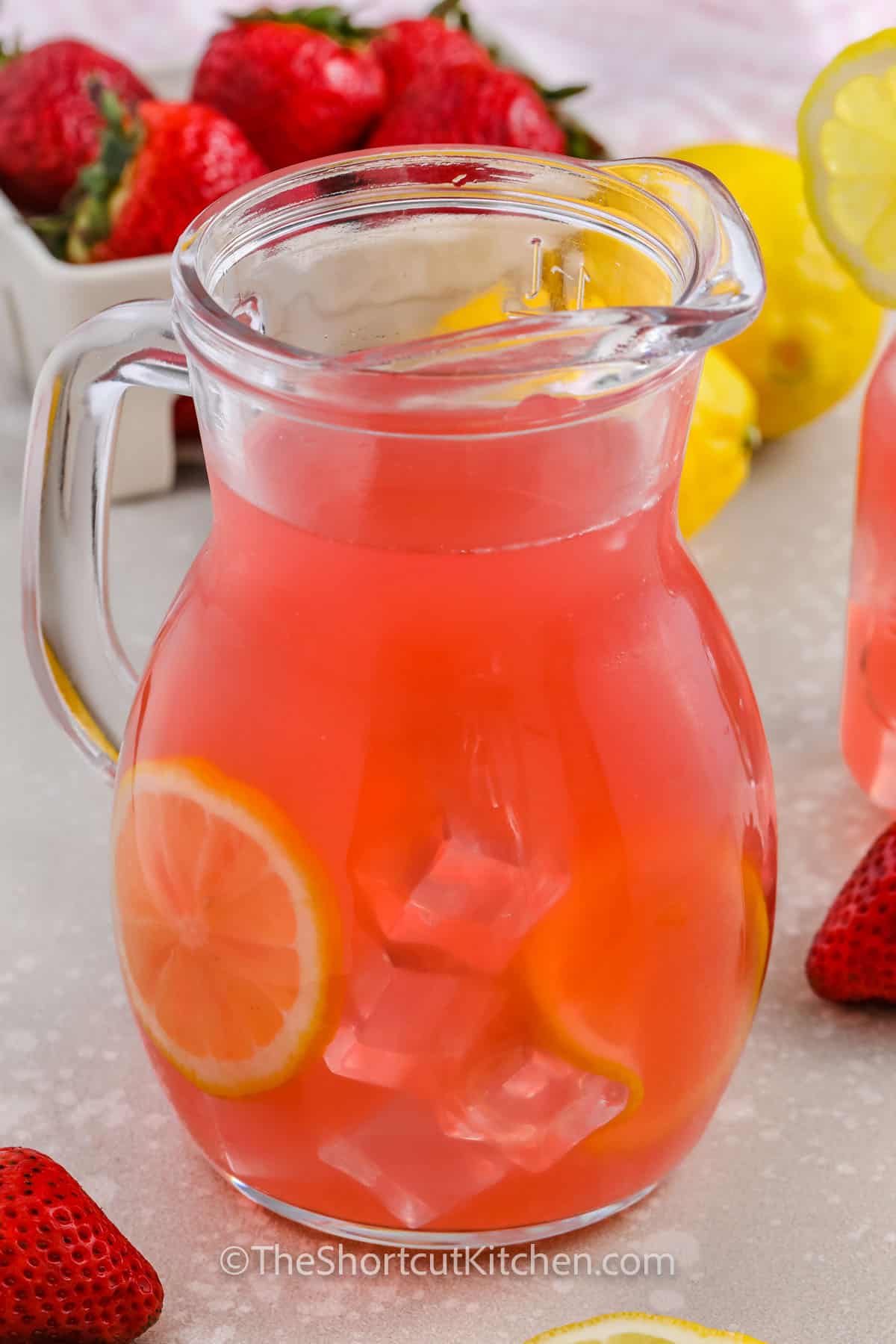 Strawberry Lemonade Vodka in a pitcher with lemon slices
