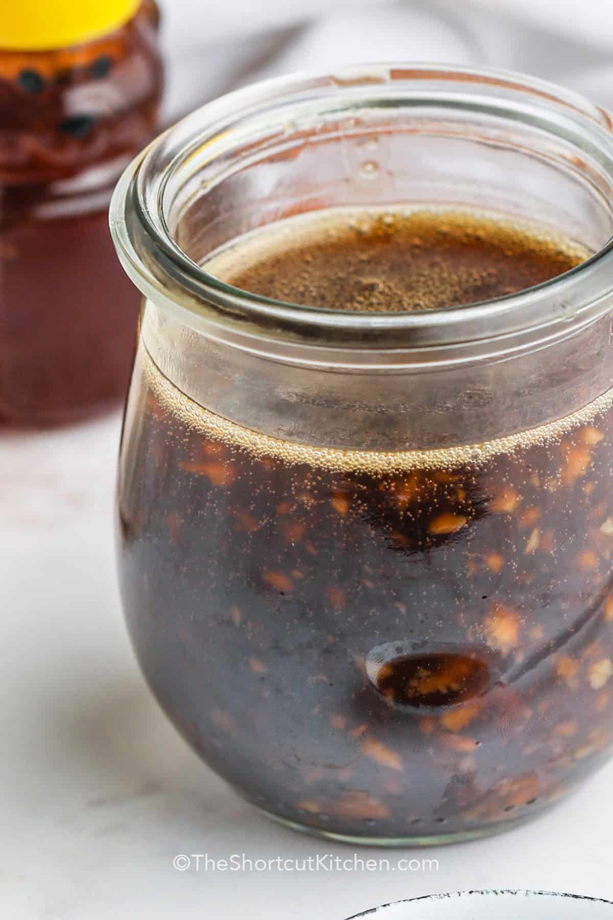 cropped homemade honey garlic sauce in a jar