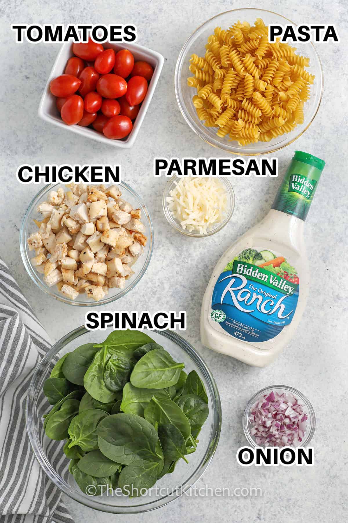 tomatoes , pasta , chicken , parmesan , spinach , onion and ranch with labels to make Chicken Pasta Salad