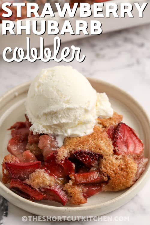 plated slice of Strawberry Rhubarb Cobbler and writing