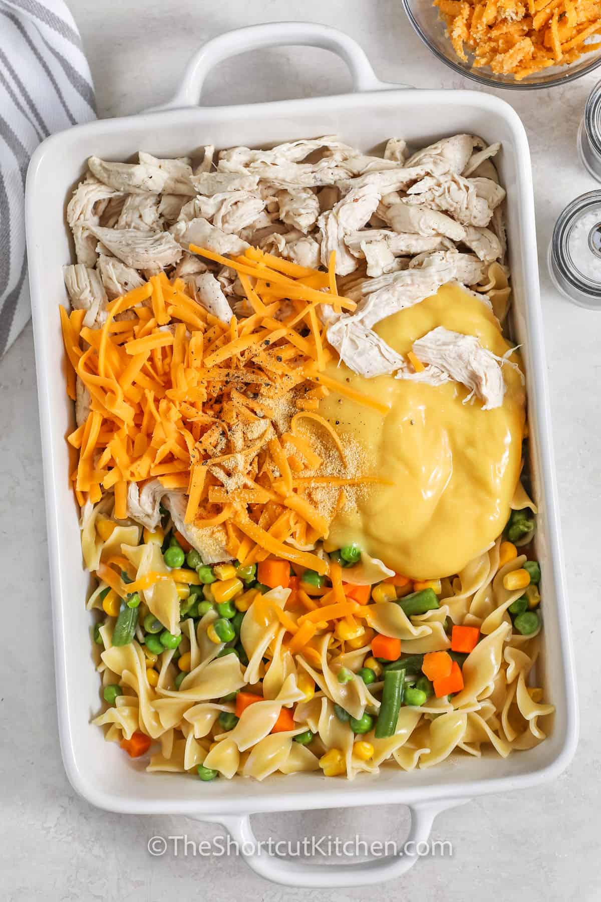 Ingredients to make chicken and noodle casserole combined in a casserole dish