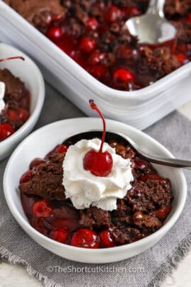 bowls of Chocolate Cherry Dump Cake with dish full in the back