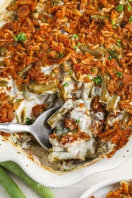 cropped spoon scooping canned green bean casserole