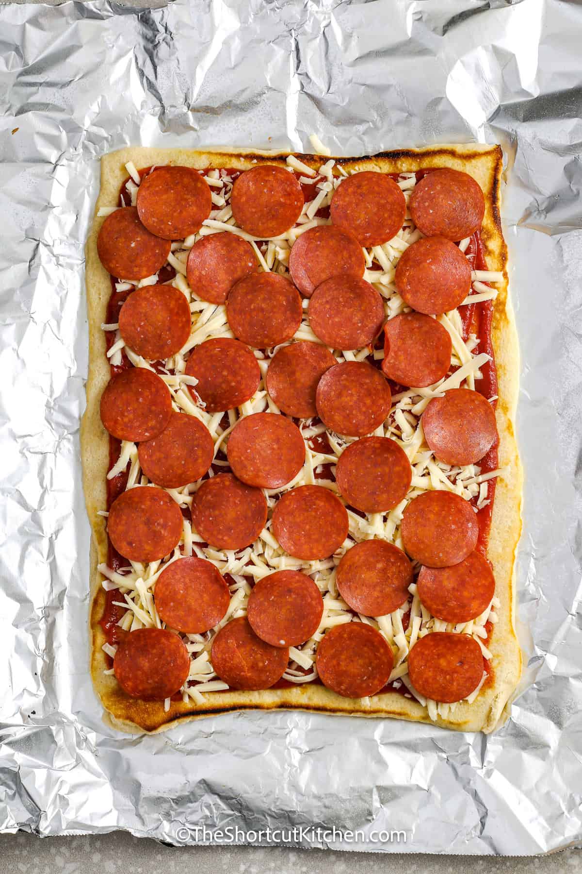 cooked grilled pizza with sauce and cheese and pepperoni