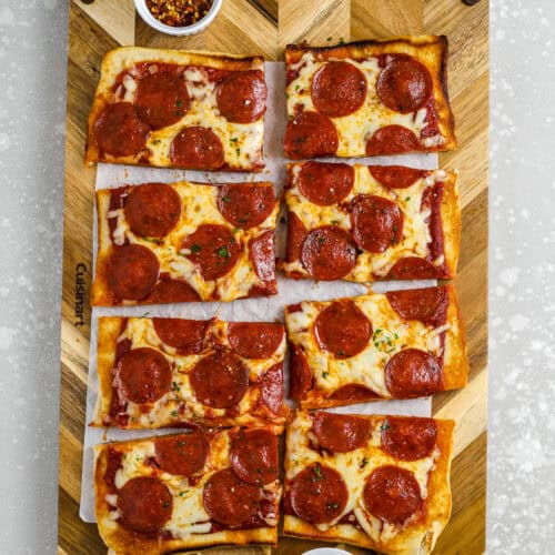 sliced grilled pizza on a cutting board
