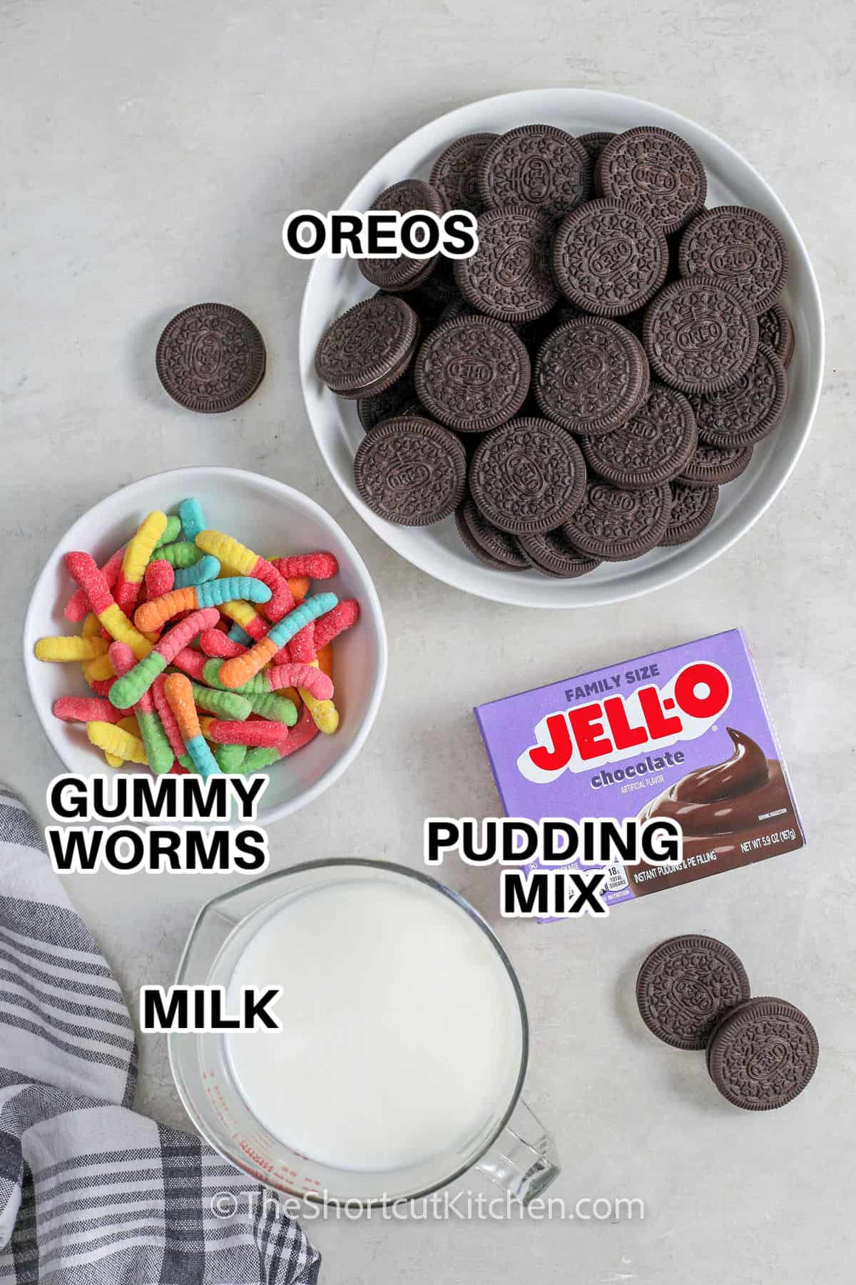 oreos , gummy worms , pudding mix , and milk with labels