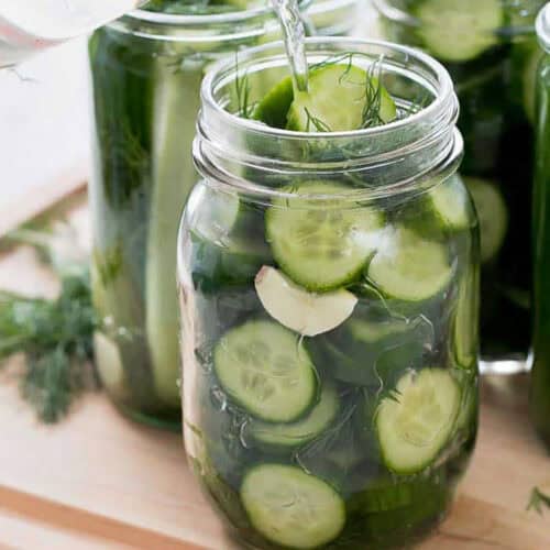 adding brine to jar to make Refrigerator Dill Pickle Recipe