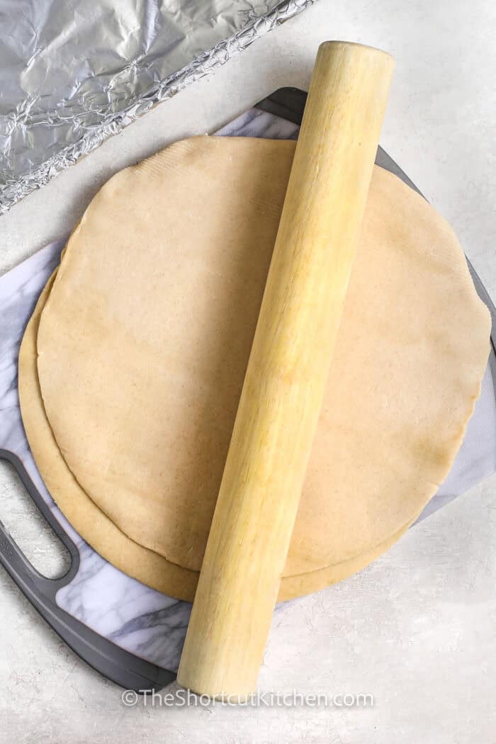 flattening pie crusts with a rolling pin