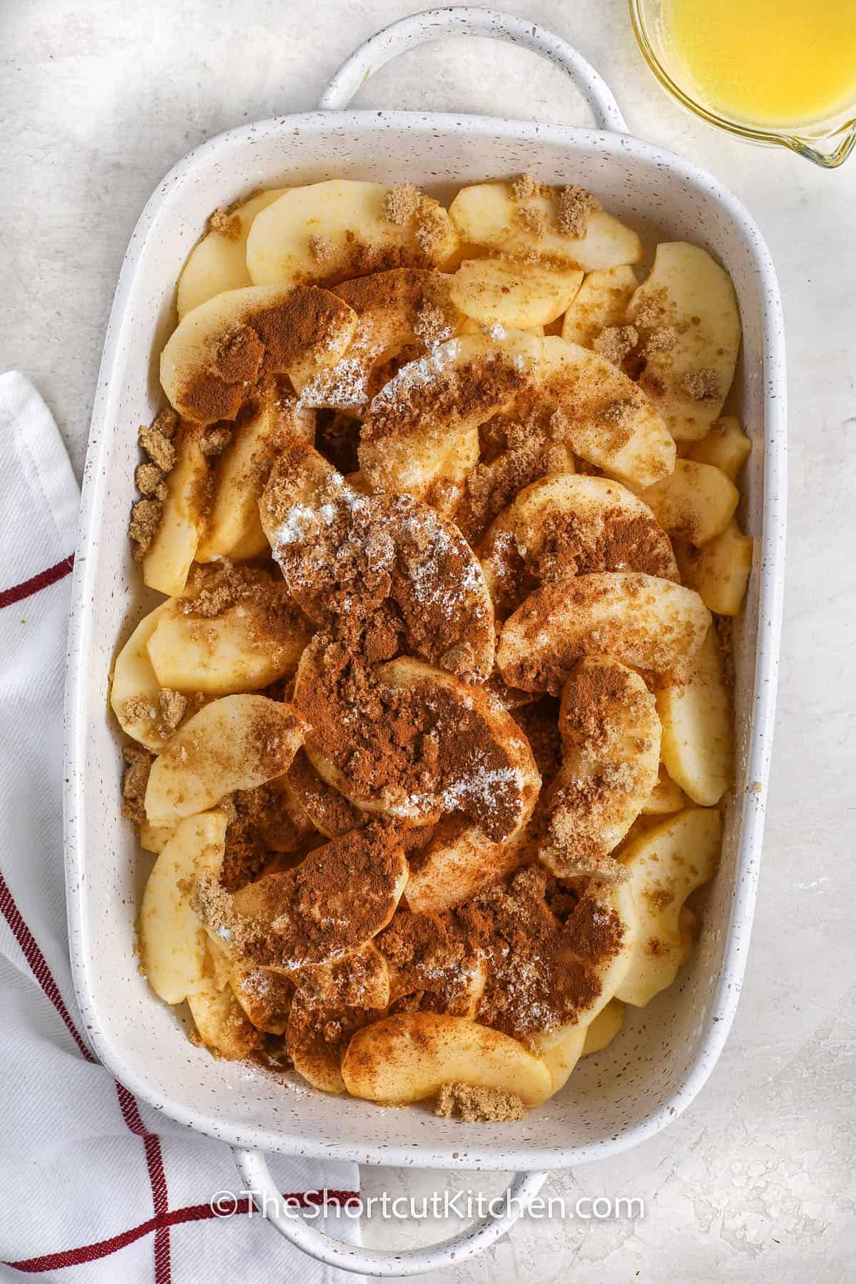 adding seasonings to Baked Apple Slices