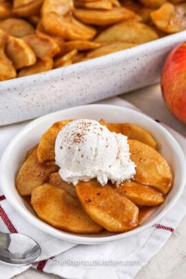 Baked Apple Slices in the casserole dish and plated with ice cream and cinnamon