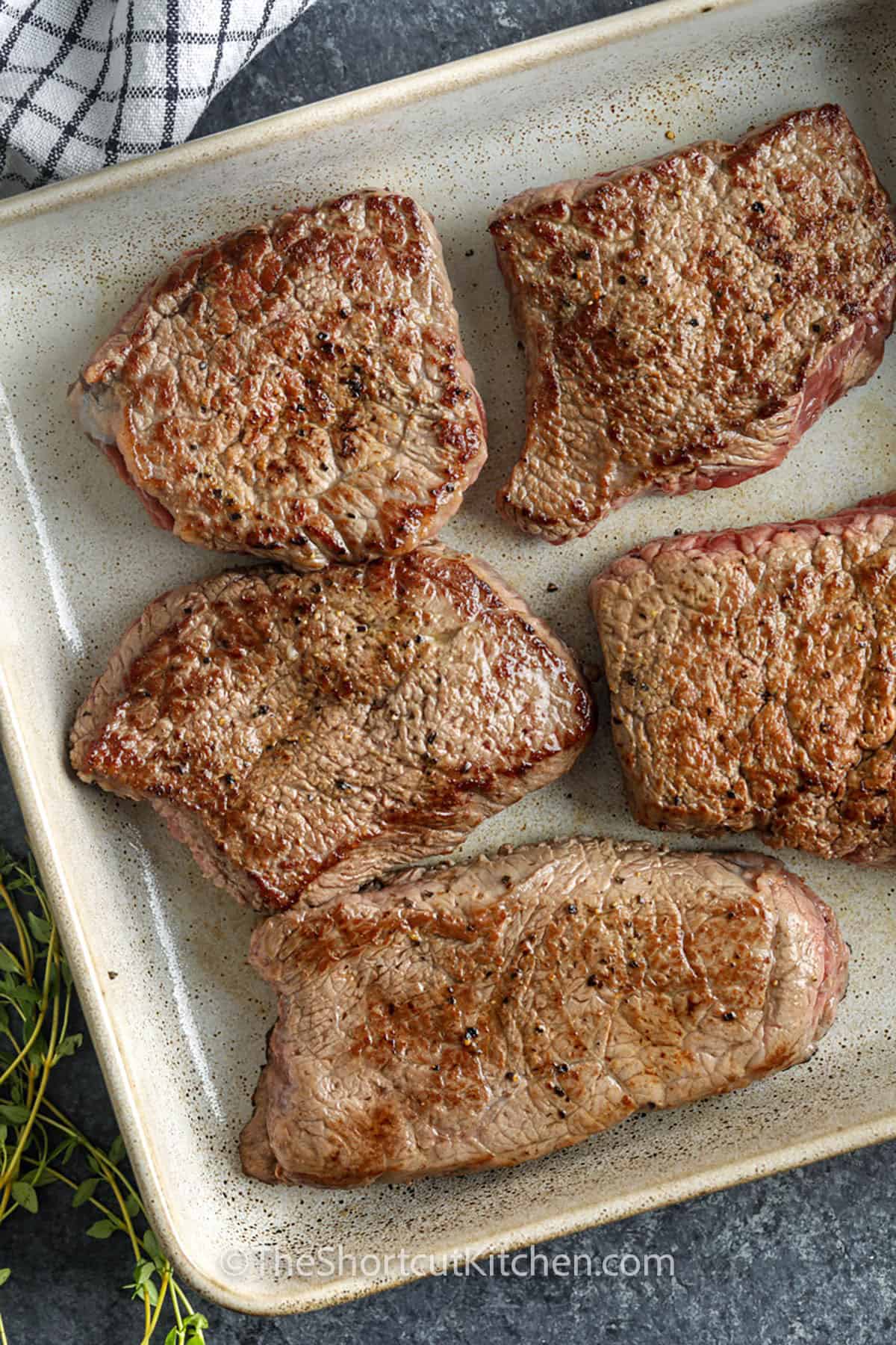 cooked steaks in a dish to make Braised Steak and Mushrooms