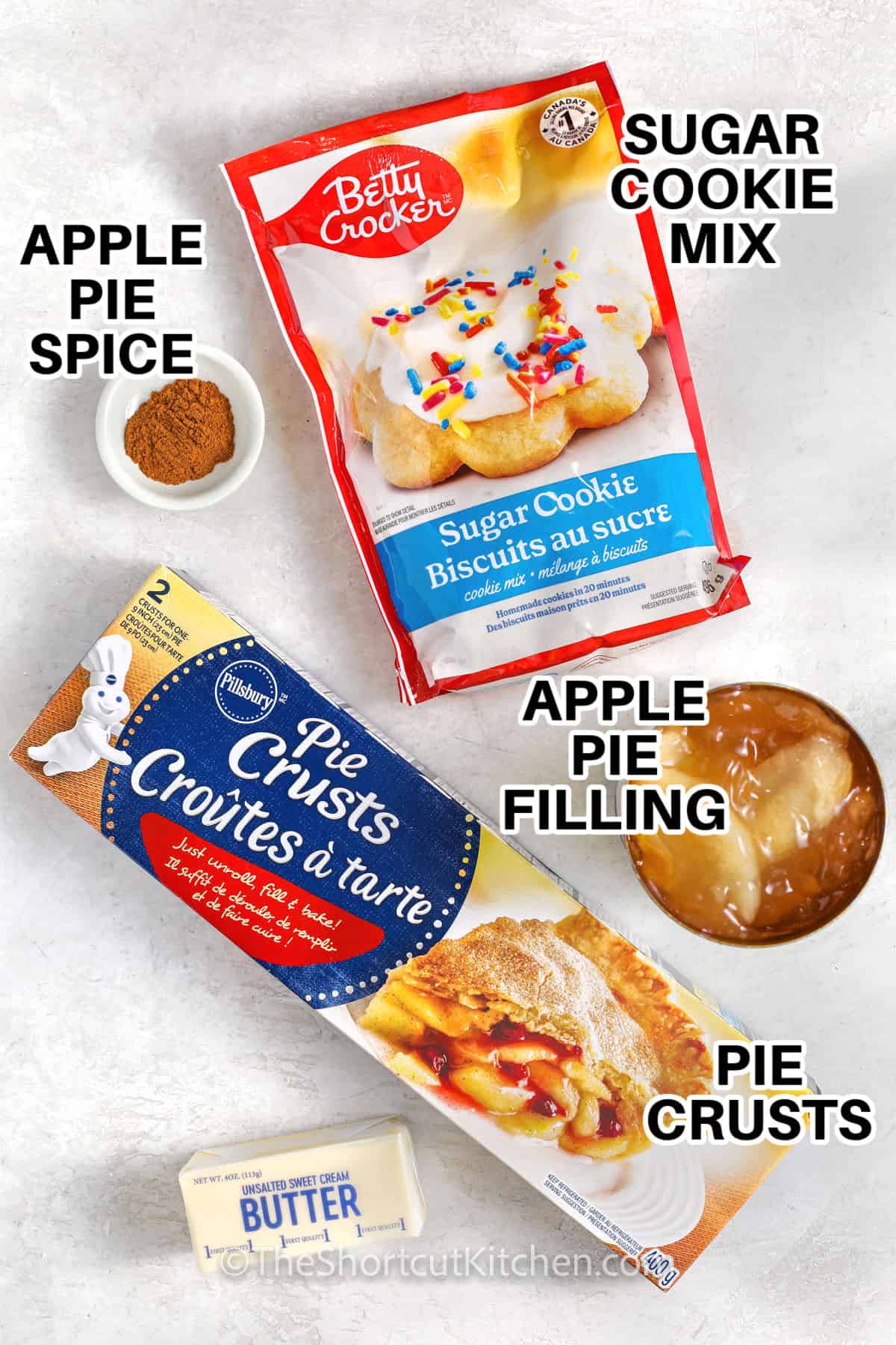 sugar cookie mix , apple pie spice , apple pie filling , pie crusts , and buter with labels to make Apple Pie Bars