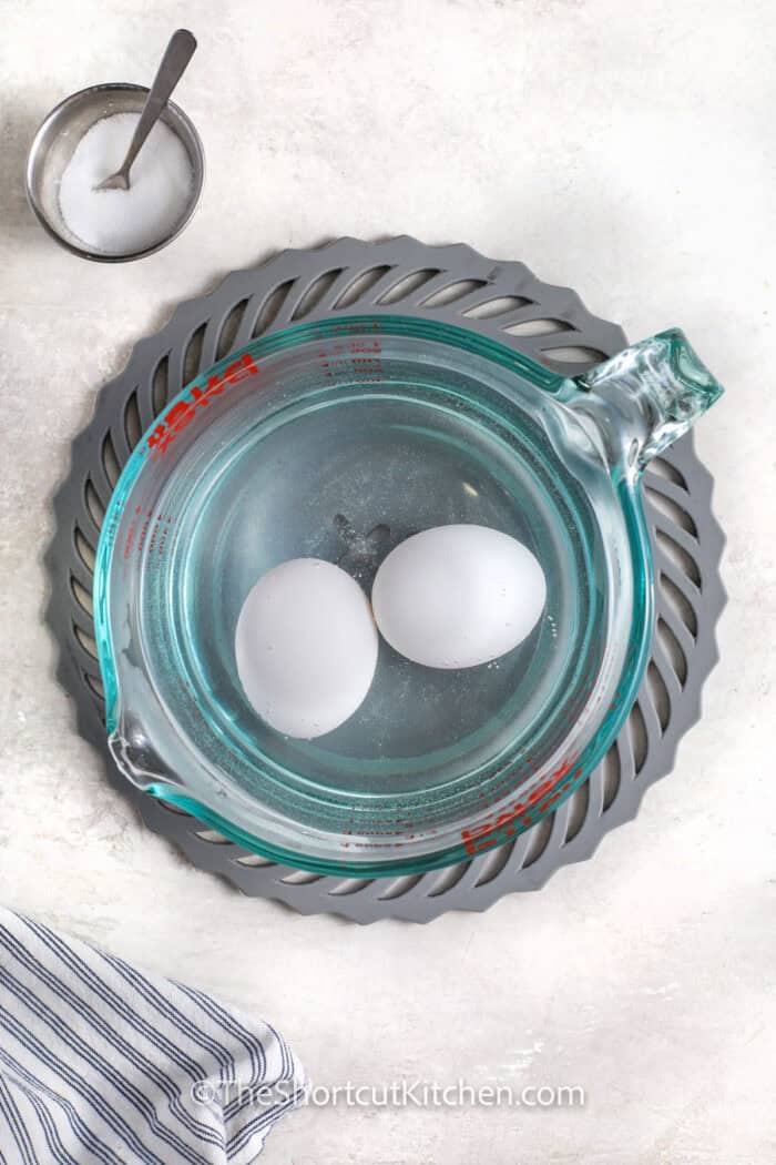 adding eggs to salt water to make Microwave Hard Boiled Eggs