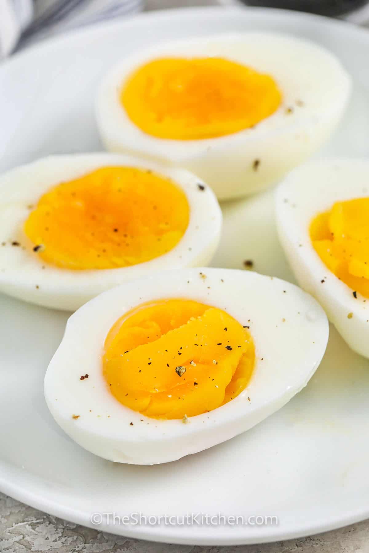 close up of seasoned Microwave Hard Boiled Eggs on a plate