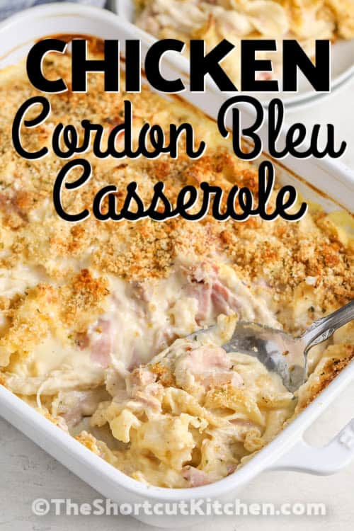 A chicken cordon bleu casserole being served with a spoon with a title