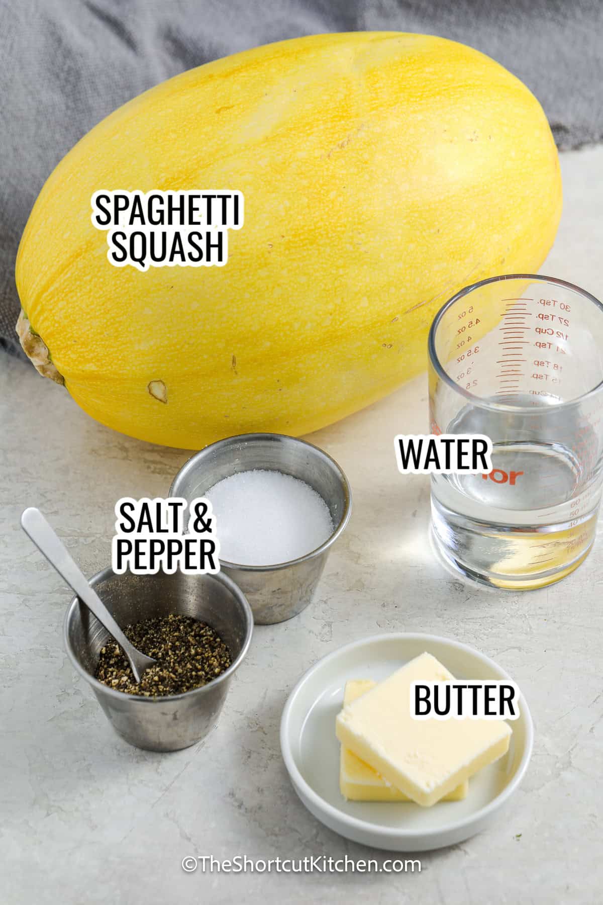 ingredients assembled to make microwave spaghetti squash, including spaghetti squash, water, salt and pepper, and butter