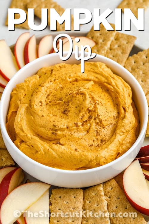 A bowl of pumpkin dip with apples and graham wafers with a title