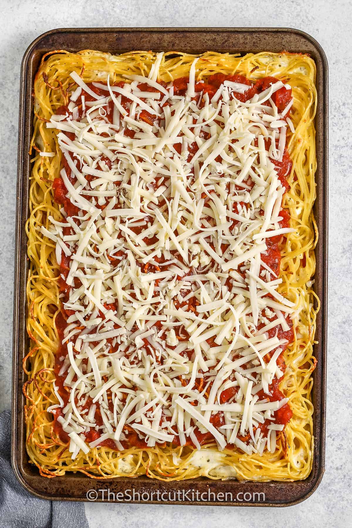 adding mozzarella to Spaghetti Pizza