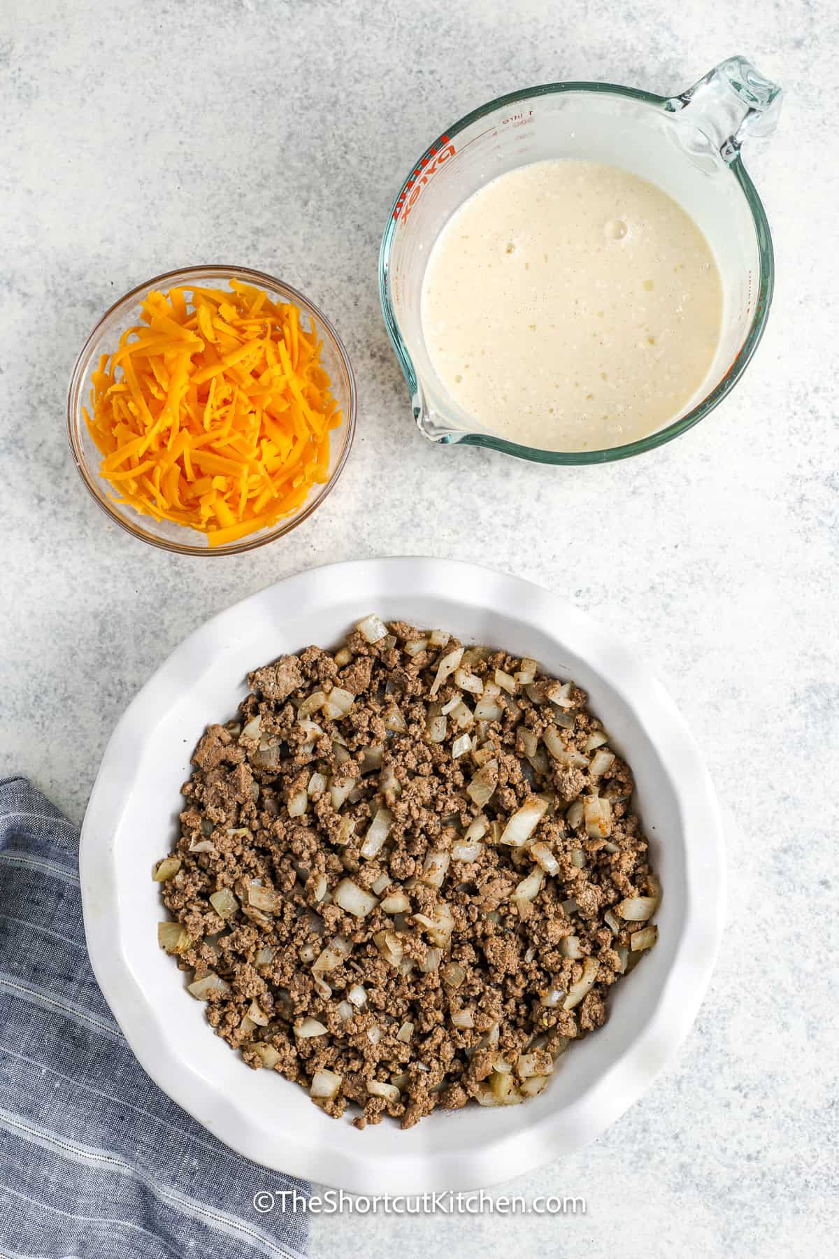 Bisquick Cheeseburger Pie being assembled