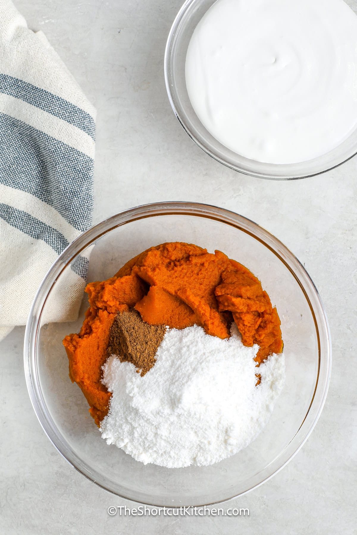 ingredients to make pumpkin dip being combined in a bowl