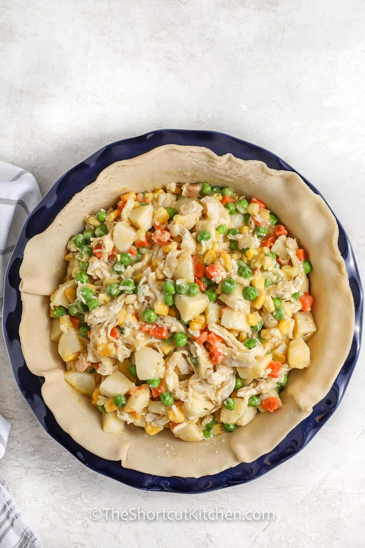 adding filling to pie shell to make Best Chicken Pot Pie