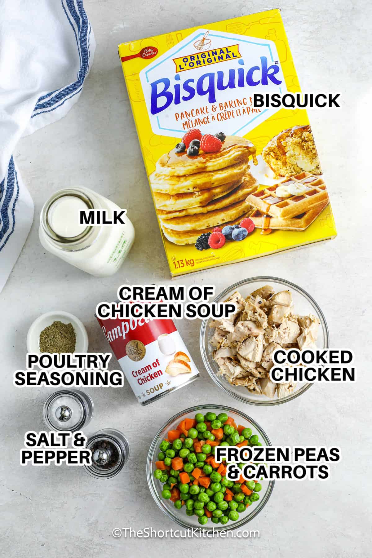 ingredients to make bisquick chicken and dumplings labeled: bisquick, milk, cream of chicken soup, cooked chicken, frozen peas & carrots, poultry seasoning, and salt & pepper